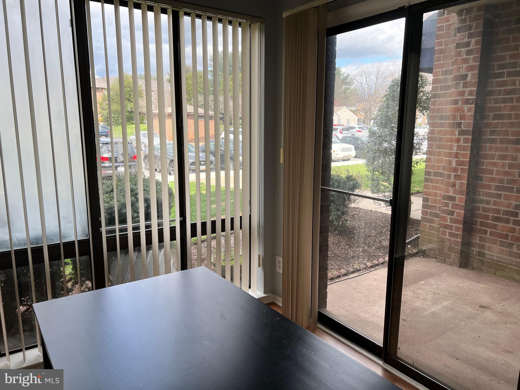 8141 Needwood Road, Unit 104 Derwood, MD 20855 - Photo 13 of 42 a view of a balcony with floor to ceiling window with wooden floor