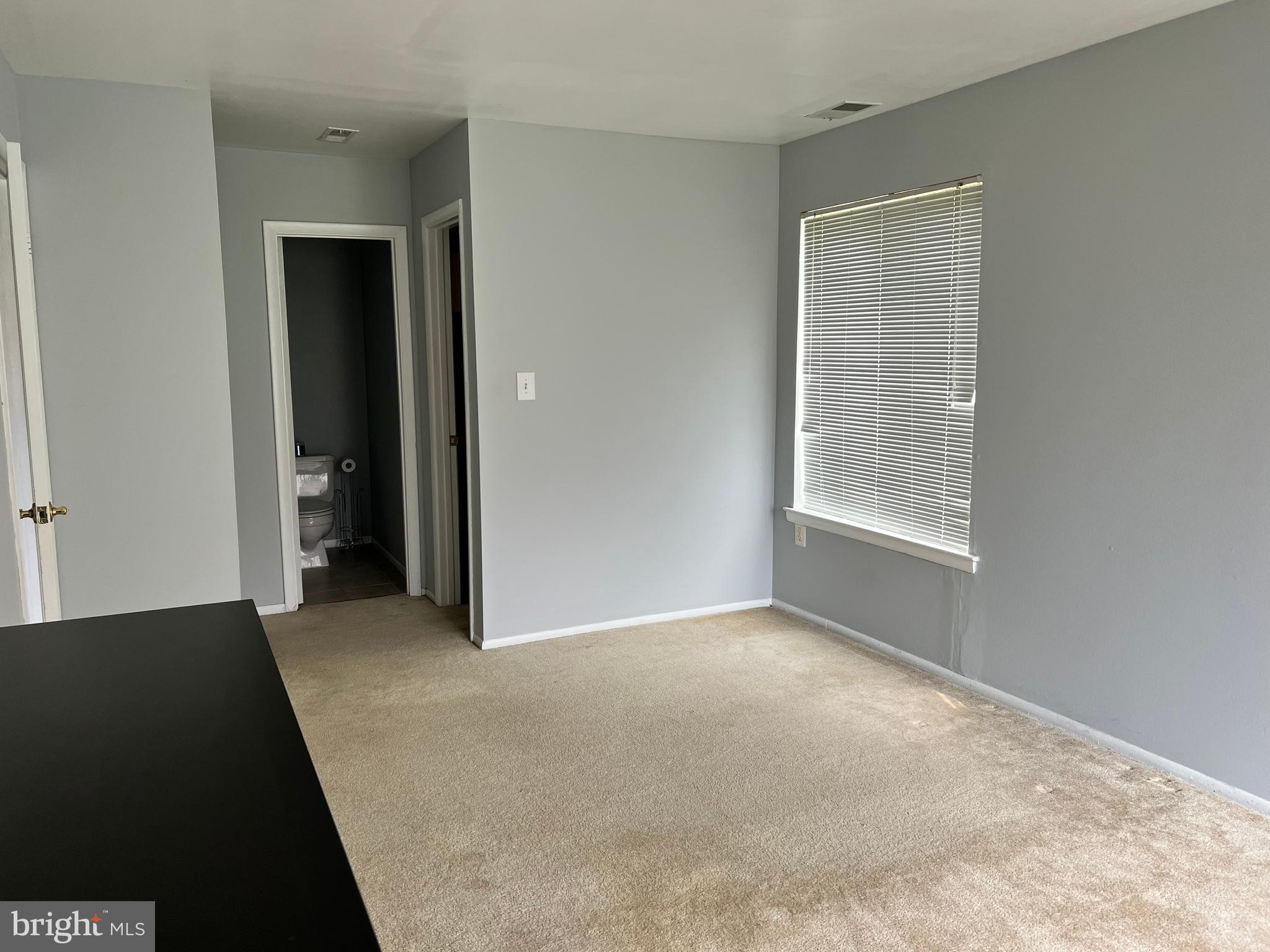 8141 Needwood Road, Unit 104 Derwood, MD 20855 - Photo 23 of 42 an empty room with windows