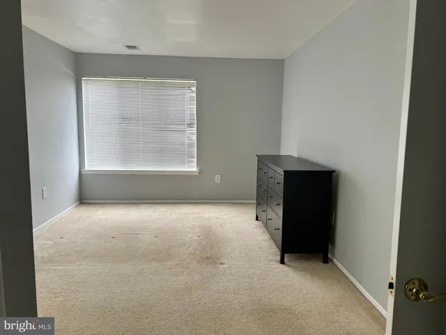 an empty room with a empty space and windows