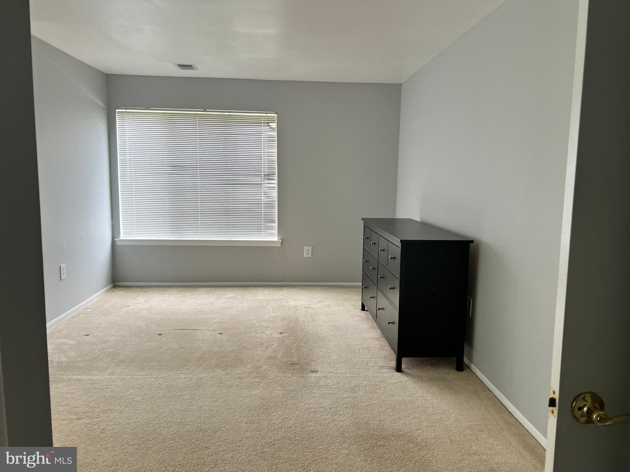 8141 Needwood Road, Unit 104 Derwood, MD 20855 - Photo 25 of 42 an empty room with a empty space and windows