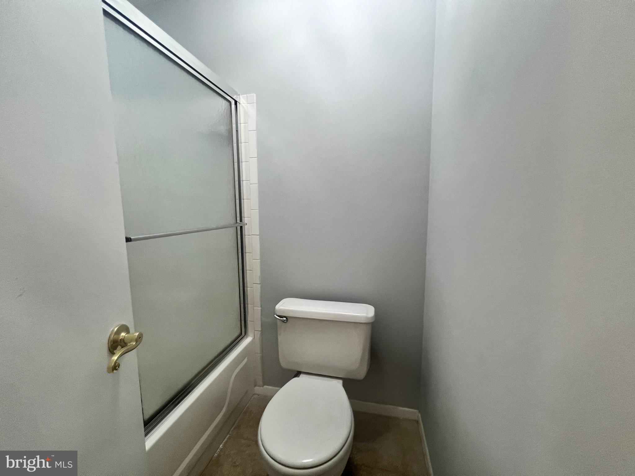 8141 Needwood Road, Unit 104 Derwood, MD 20855 - Photo 29 of 42 a white toilet sitting next to a shower
