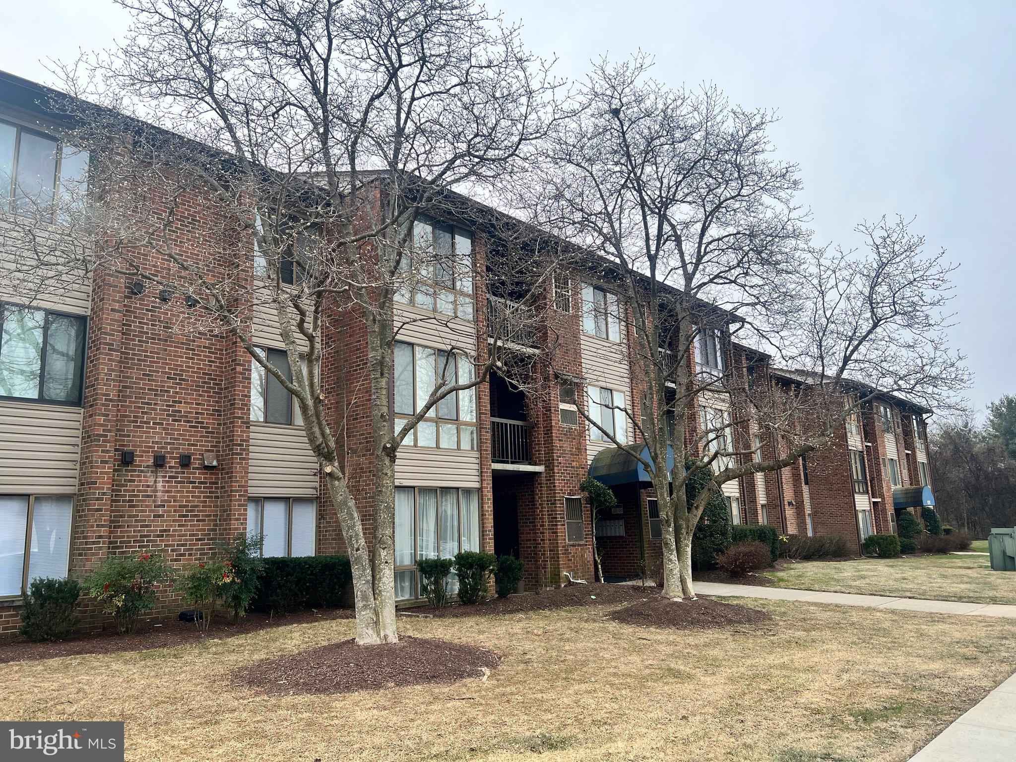 8141 Needwood Road, Unit 104 Derwood, MD 20855 - Photo 3 of 42 a street corner of a building with trees
