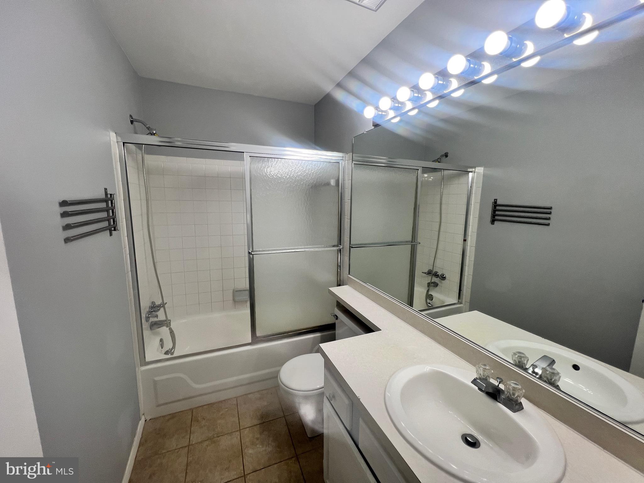 8141 Needwood Road, Unit 104 Derwood, MD 20855 - Photo 32 of 42 a bathroom with a sink toilet and shower