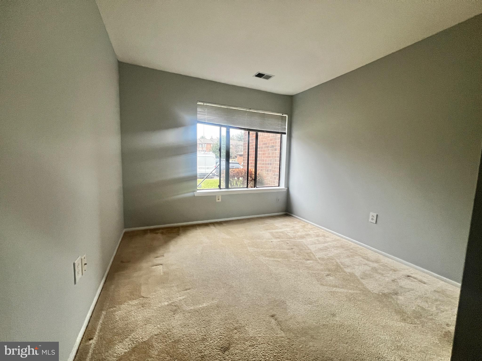 8141 Needwood Road, Unit 104 Derwood, MD 20855 - Photo 38 of 42 an empty room with windows