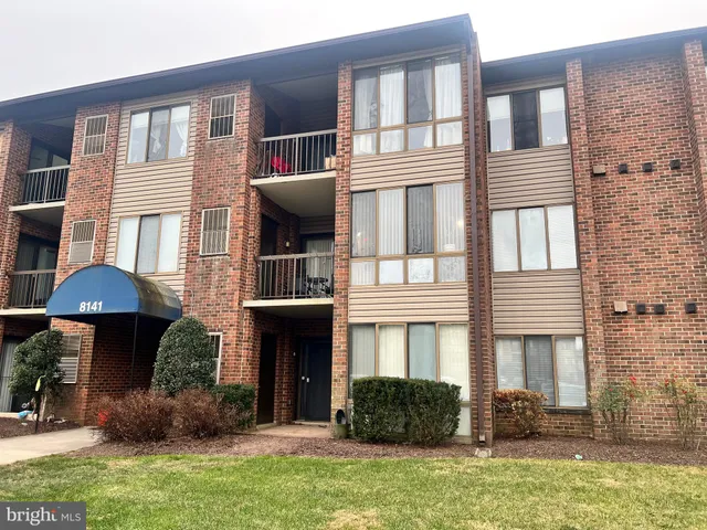 a front view of a house with yard and furniture