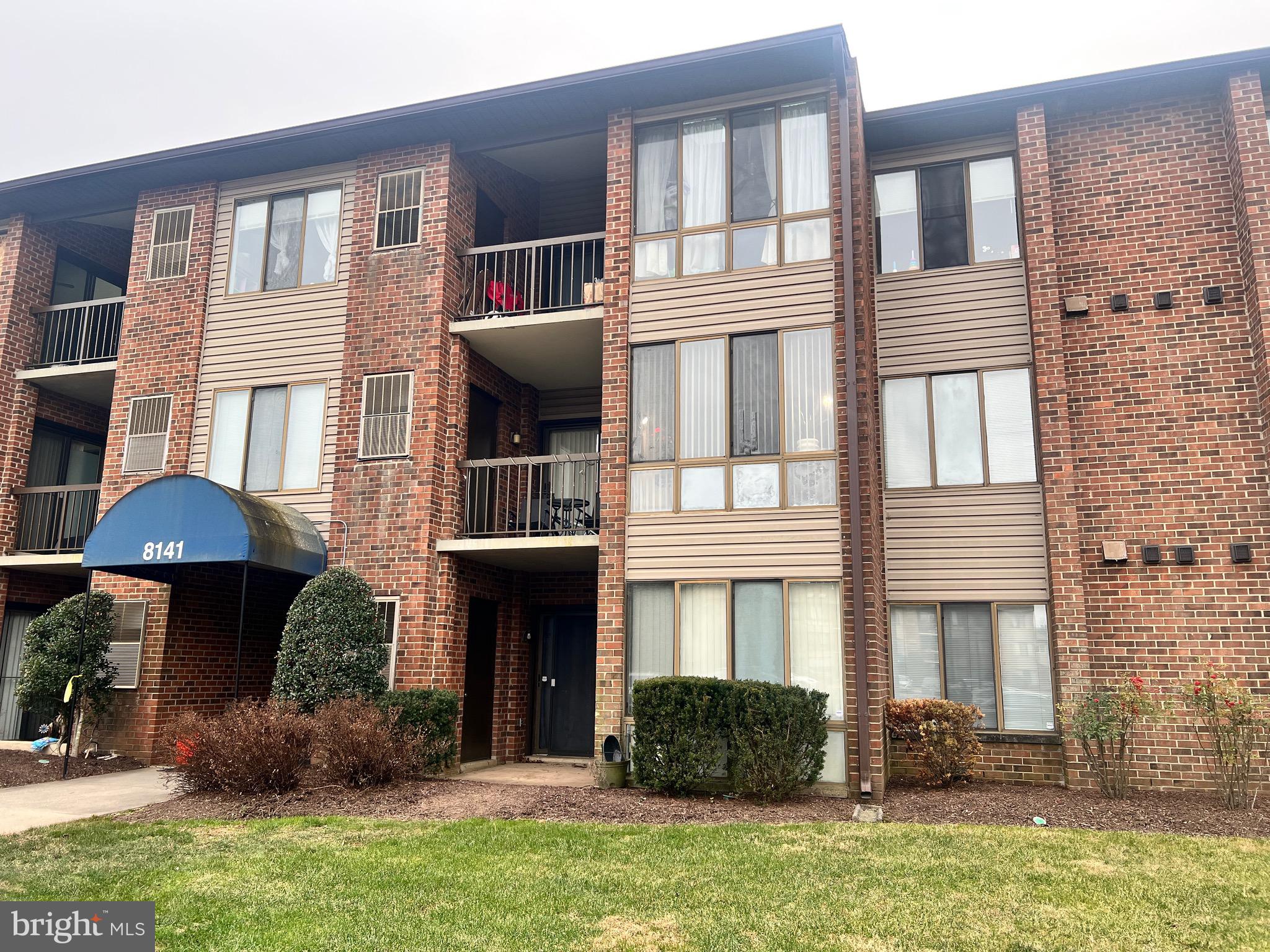 8141 Needwood Road, Unit 104 Derwood, MD 20855 - Photo 4 of 42 a front view of a house with yard and furniture