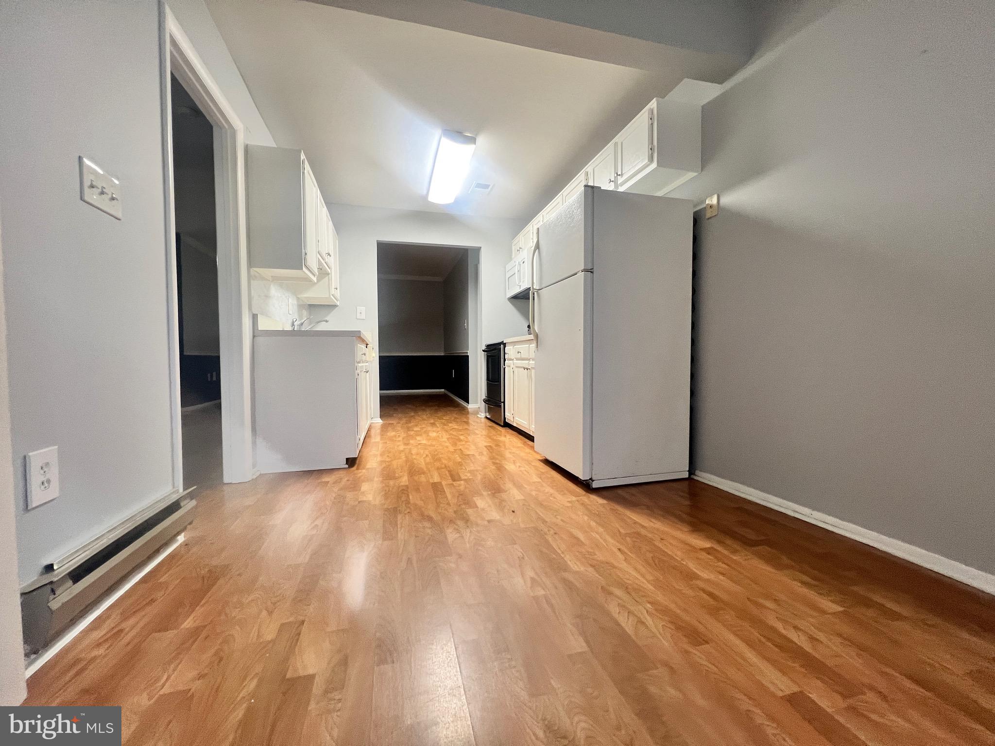 8141 Needwood Road, Unit 104 Derwood, MD 20855 - Photo 8 of 42 a view of empty room with wooden floor