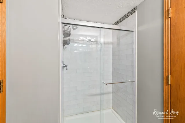 a bathroom with a glass shower door