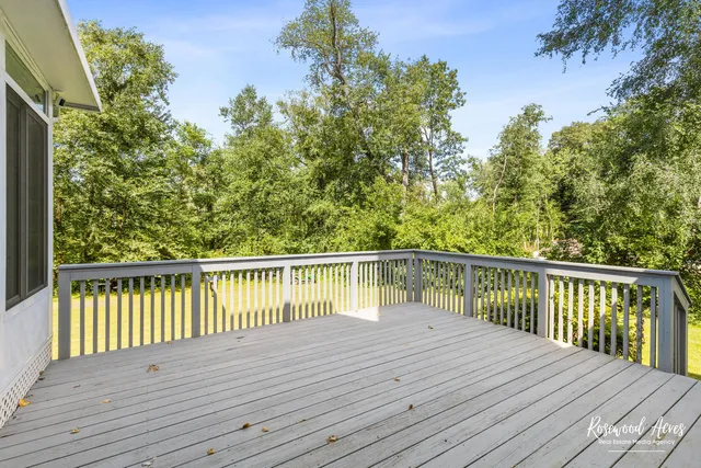 a view of balcony with wooden floor and fence