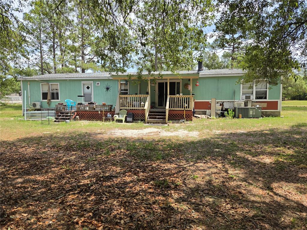 4738 Southwest 166th Court Road Ocala, FL 34481 - Photo 13 of 14 a view of a house with backyard