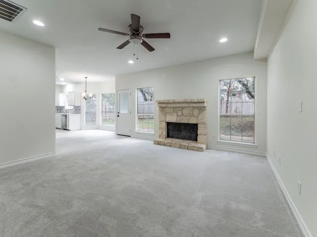 a view of empty room with a fireplace