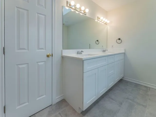 a room with a sink and a mirror