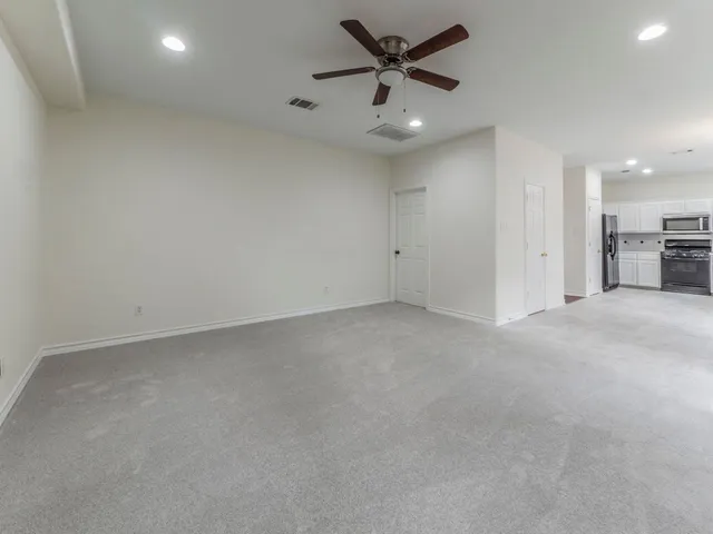 an empty room with a empty space and a ceiling fan