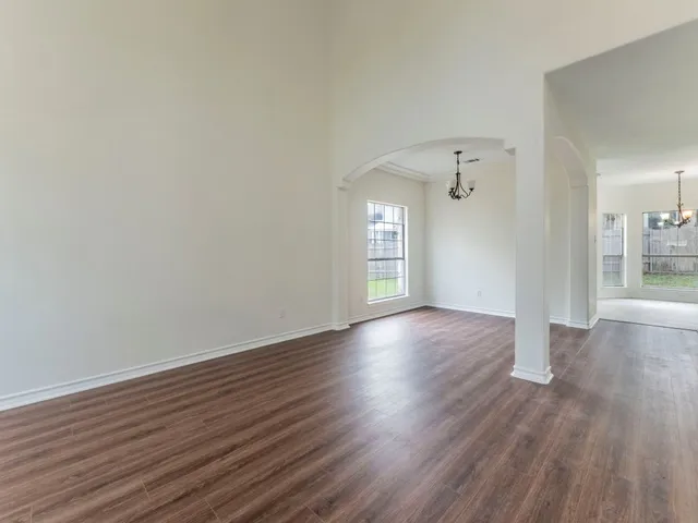 a view of a room with wooden floor
