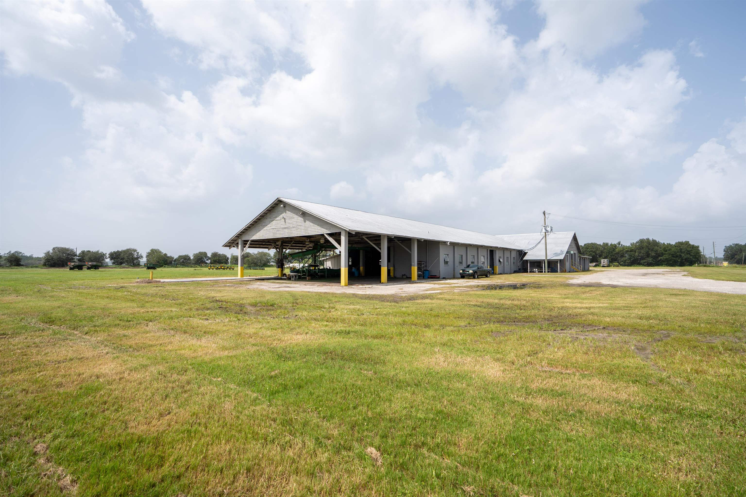 1105 County Road 13A Elkton, FL 32033 - Photo 21 of 57 a view of a house with a big yard and a large tree
