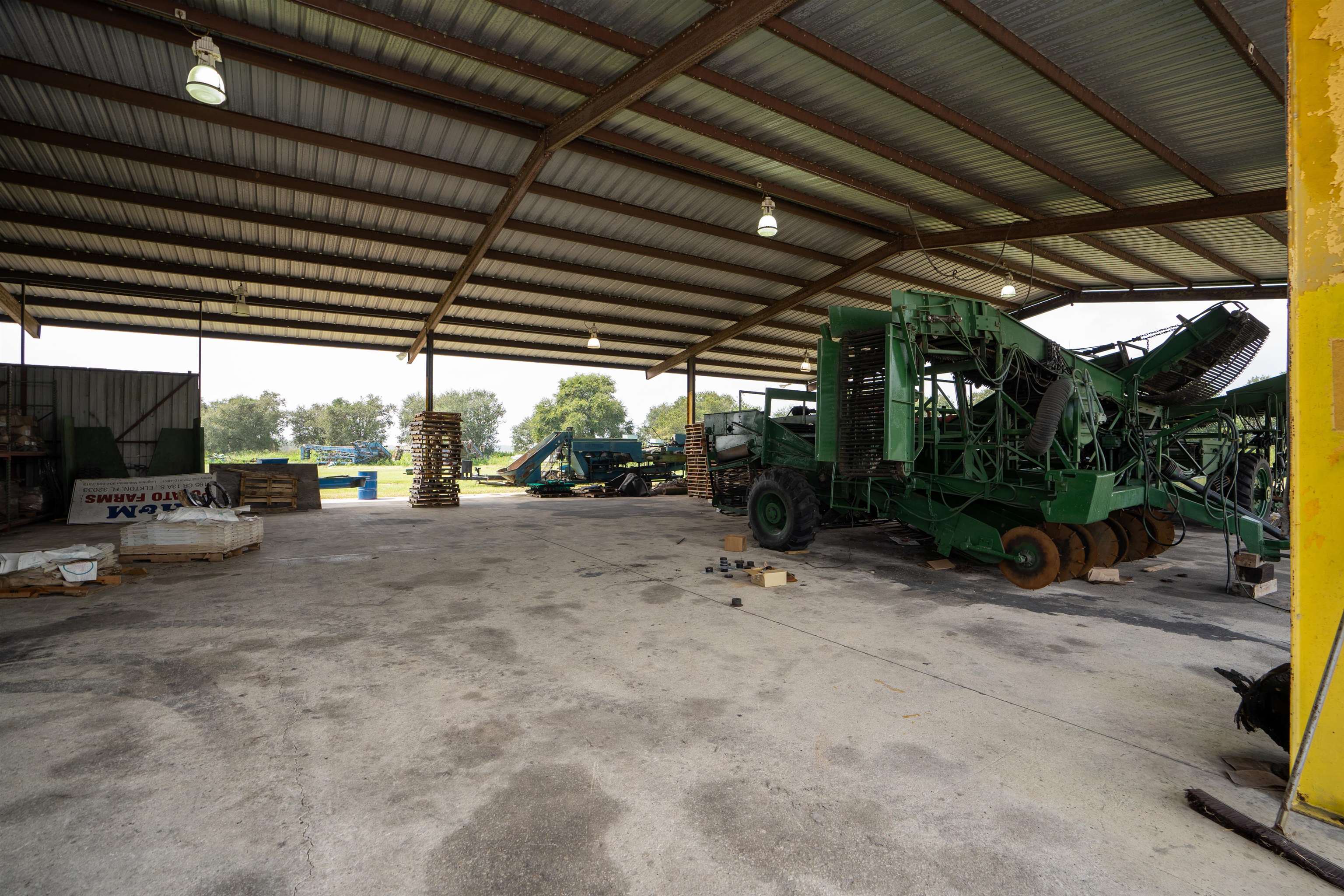 1105 County Road 13A Elkton, FL 32033 - Photo 28 of 57 a view of patio with a table and chairs under an umbrella with a small yard