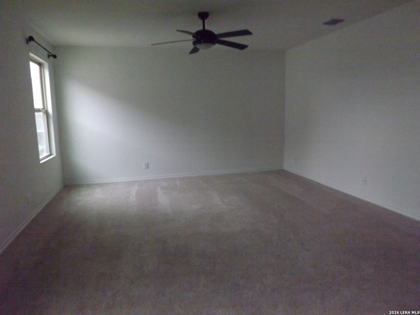 6835 Alaskan Wy. Converse, TX 78109 - Photo 8 of 22 an empty room with a window and a fan
