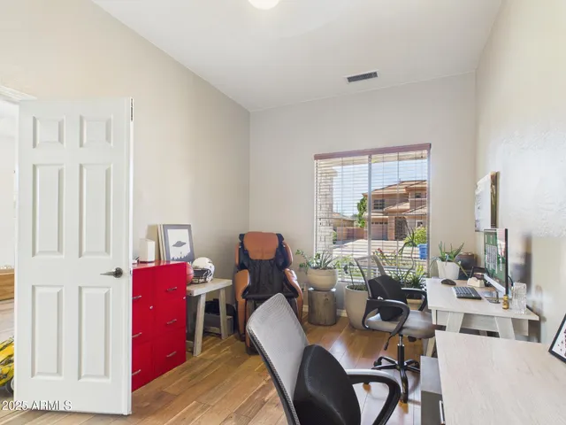 a living room with furniture a large window and gym equipment