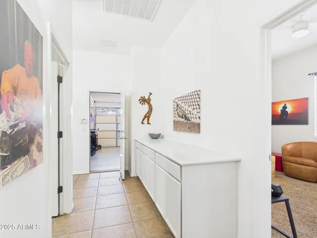 a hallway with cabinets and a couch