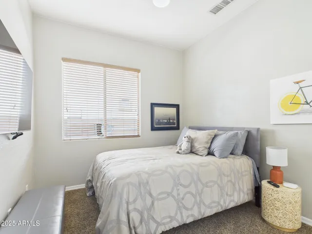 a bedroom with a bed and dresser