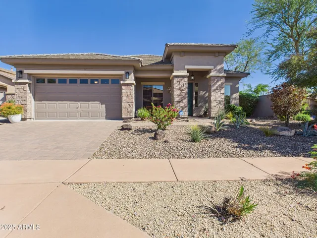 a view of a house with potted plants