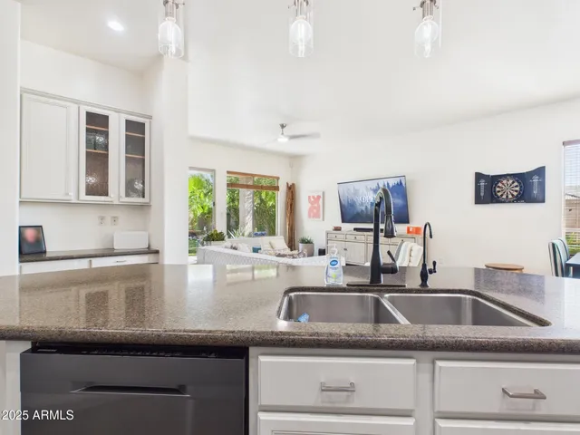 a kitchen with granite countertop a sink and a stove