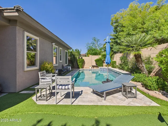 a view of a backyard with sitting area