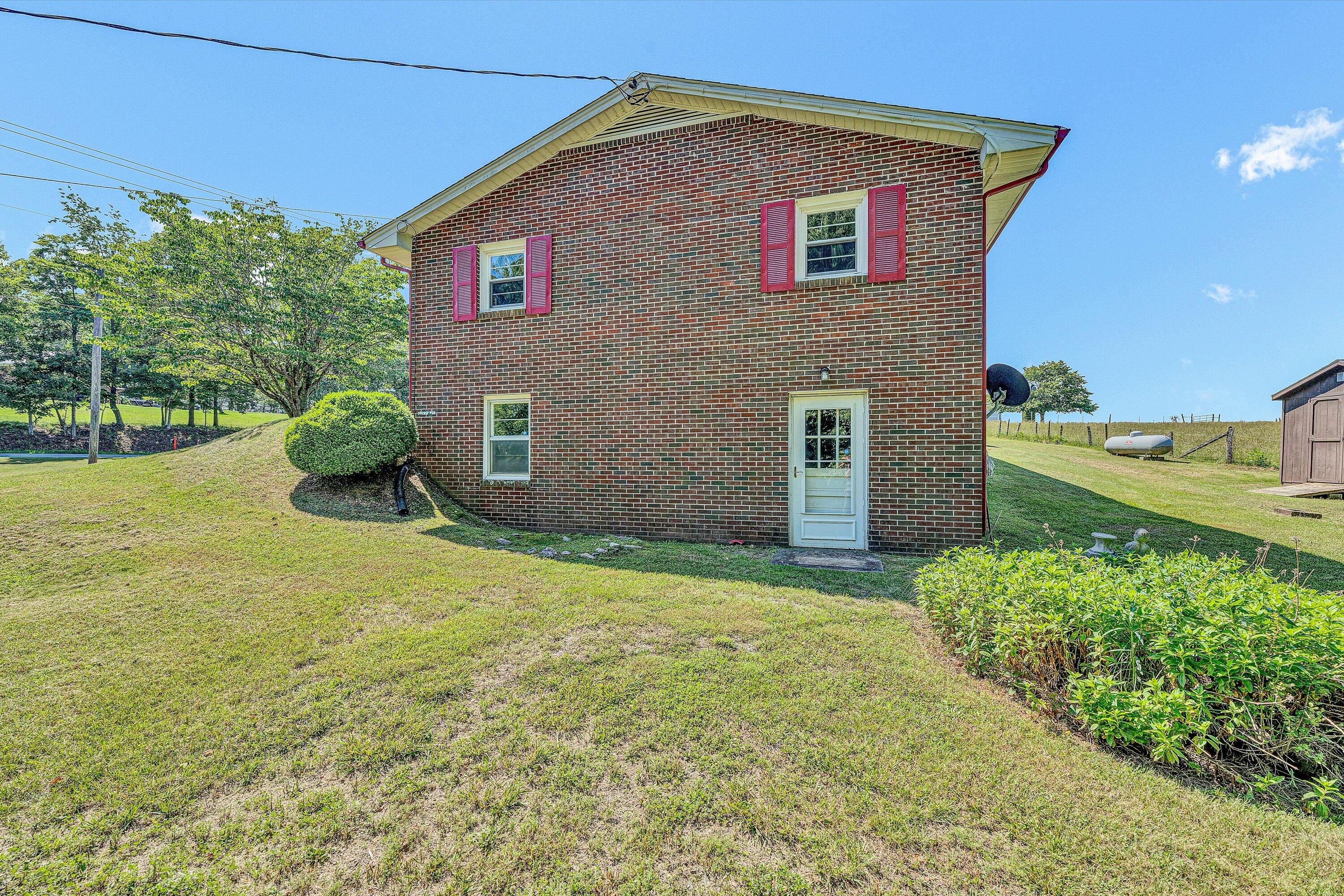 20083 Snow Creek Road Penhook, VA 24137 - Photo 25 of 31 Right side of home with door to basement
