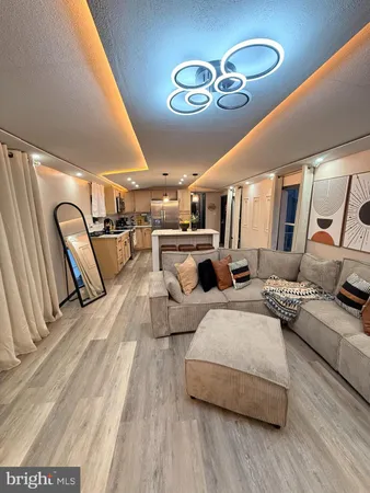 a living room with furniture and a chandelier