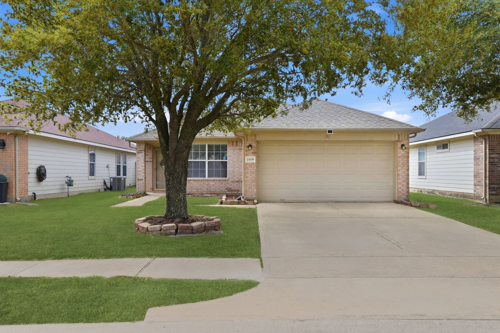 a front view of a house with a yard and a garage