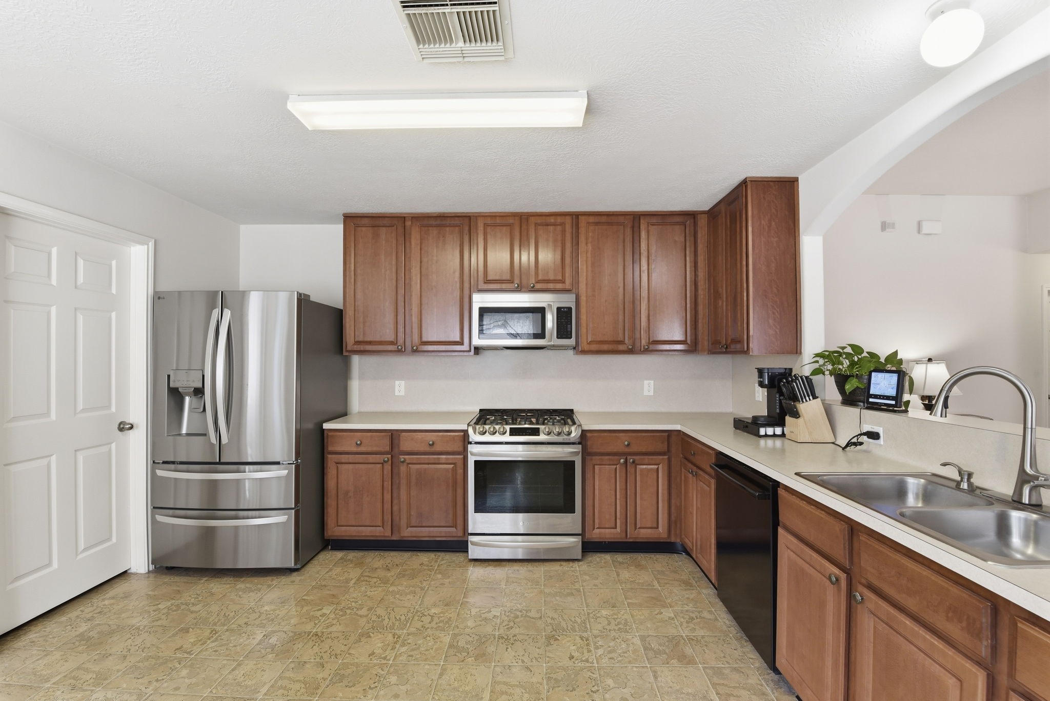 21639 Falvel Misty Drive Spring, TX 77388 - Photo 5 of 11 a kitchen with stainless steel appliances granite countertop a sink stove and refrigerator