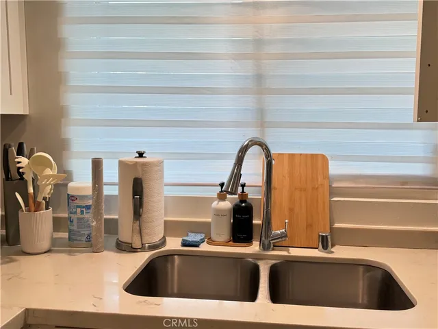 a kitchen with a sink and a refrigerator