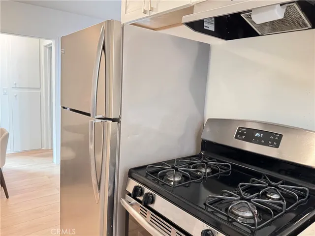 a stove top oven sitting inside of a kitchen