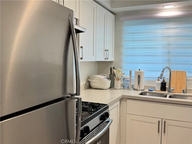 a kitchen with a refrigerator and a sink