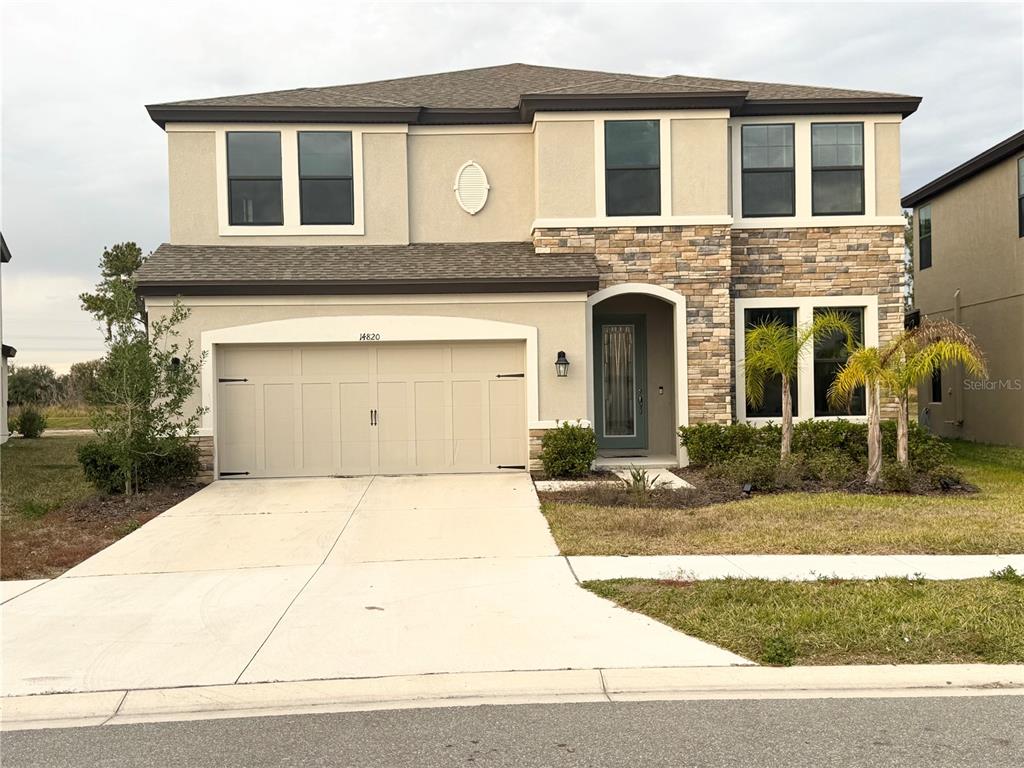 14820 Paddock Pond Avenue Lithia, FL 33547 - Photo 1 of 21 a front view of a house with garden