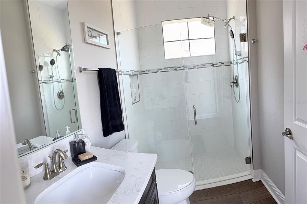 14820 Paddock Pond Avenue Lithia, FL 33547 - Photo 15 of 21 a bathroom with a granite countertop shower a toilet and a sink