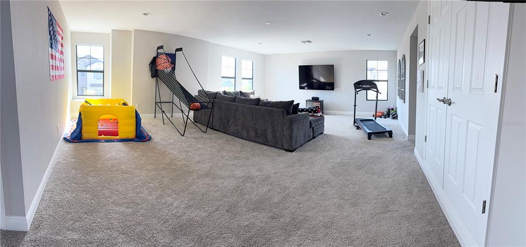 14820 Paddock Pond Avenue Lithia, FL 33547 - Photo 19 of 21 a living room with furniture and a flat screen tv