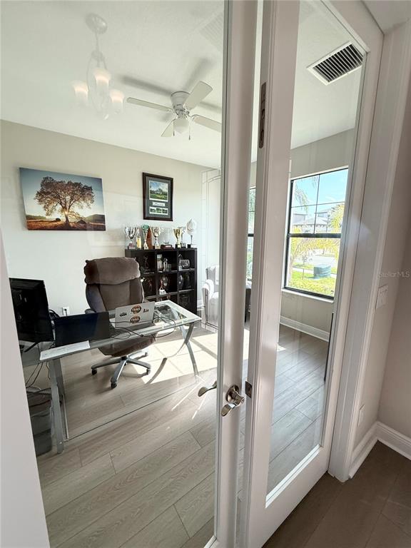 14820 Paddock Pond Avenue Lithia, FL 33547 - Photo 5 of 21 a workspace with wooden floor and windows