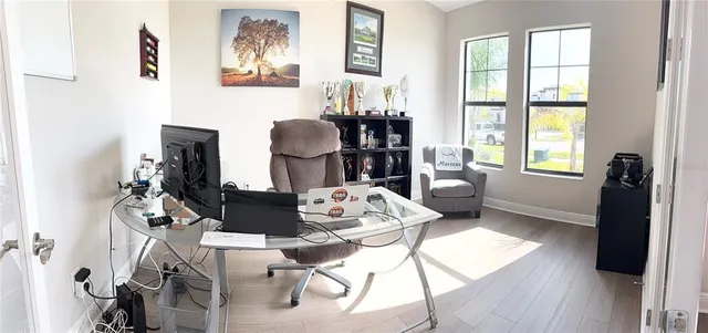 a living room with furniture and wooden floor