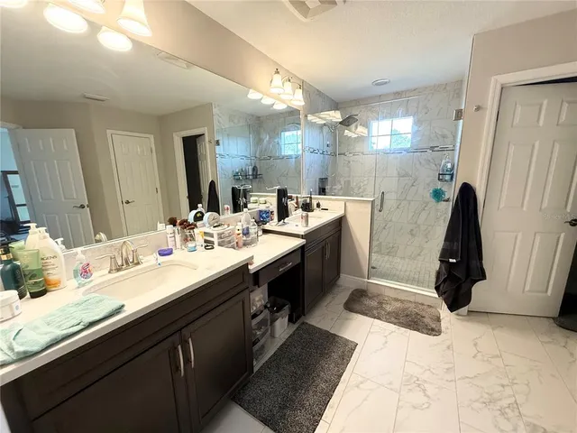 a bathroom with a double vanity sink and a mirror