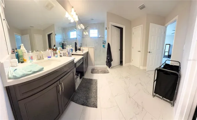 a bathroom with a sink a double vanity and mirror
