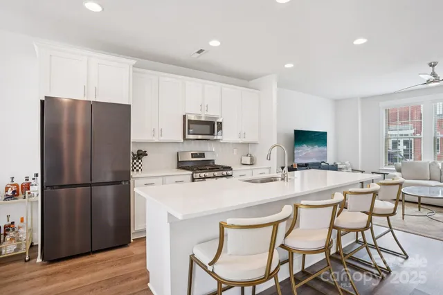 a kitchen with stainless steel appliances a refrigerator stove microwave and cabinets