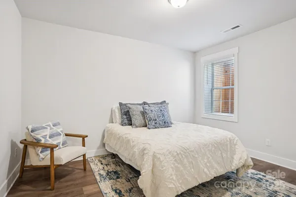 a bedroom with a bed and chair