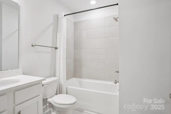 a bathroom with a toilet and a bathtub