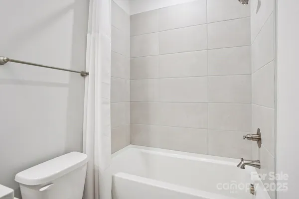 a white bath tub sitting next to a toilet