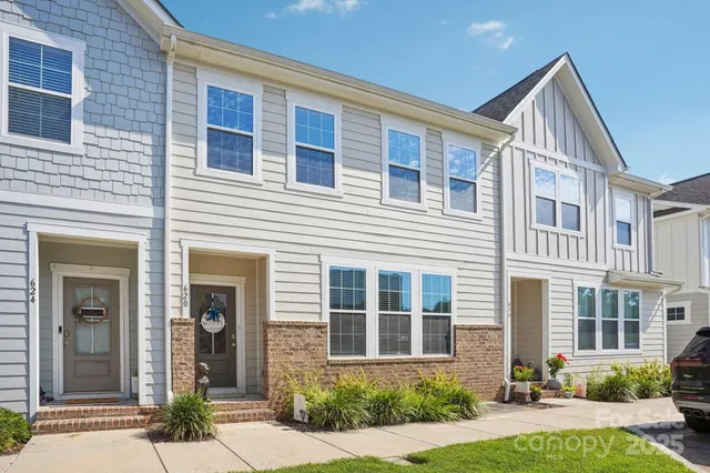 a front view of a house with yard and green space