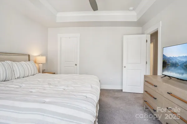 a bedroom with a bed and a mirror