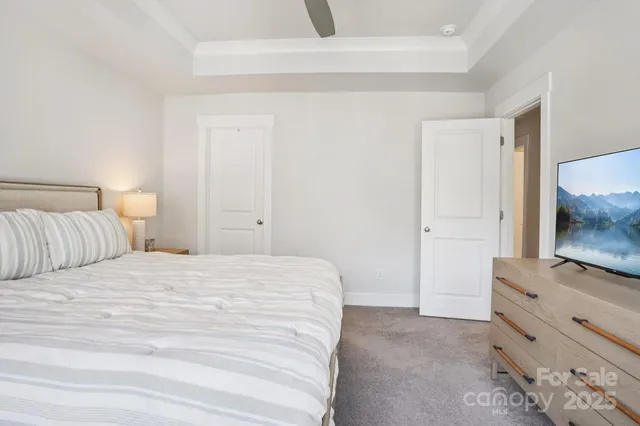 a bedroom with a bed and a mirror