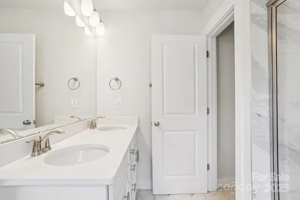 a bathroom with a double vanity sink and a mirror
