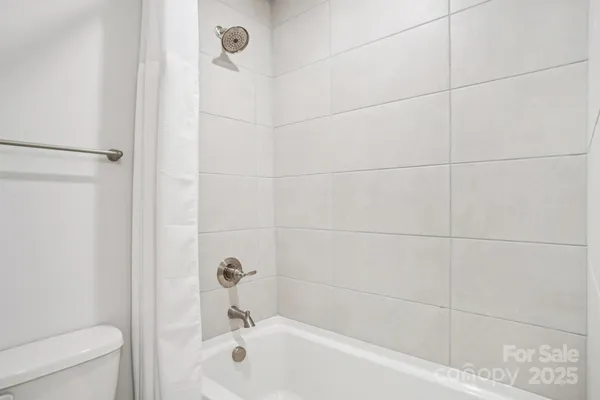 a bathroom with a bathtub and a toilet